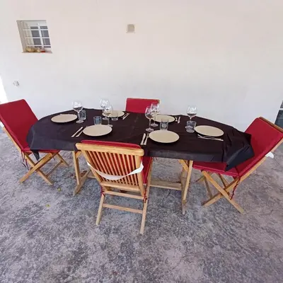 a table with chairs and wine glasses on it at Chalet con piscina LUA HOME in Manises