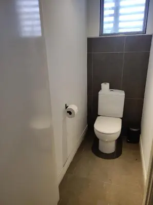 a small bathroom with a toilet and a window at Ático loft en molino antiguo in Paterna