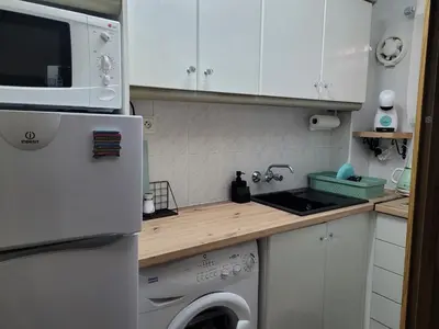 a small kitchen with a refrigerator and a dishwasher at TIGA muy cerca de la plaza de San Antonio in Cullera