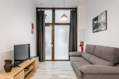 a living room with a couch and a tv at Ruzafa Market, 2 Rooms, 5 pax,wifi ACTerrace 5 Pax in Valencia