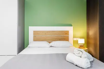 a bedroom with a bed with towels on it at Ruzafa Market, 2 Rooms, 5 pax,wifi ACTerrace 5 Pax in Valencia