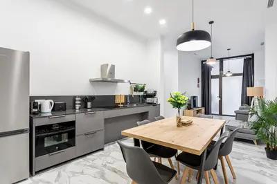 a kitchen with a wooden table and chairs at Ruzafa Market, 2 Rooms, 5 pax,wifi ACTerrace 5 Pax in Valencia