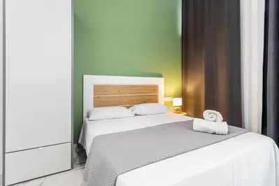 a bedroom with a white bed with a towel on it at Ruzafa Market, 2 Rooms, 5 pax,wifi ACTerrace 5 Pax in Valencia