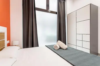 a bedroom with a white bed and a window at Ruzafa Market, 2 Rooms, 5 pax,wifi ACTerrace 5 Pax in Valencia