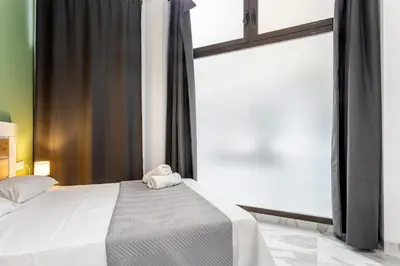 a bedroom with a bed with a towel on it at Ruzafa Market, 2 Rooms, 5 pax,wifi ACTerrace 5 Pax in Valencia