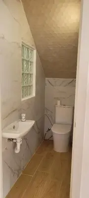a white bathroom with a sink and a toilet at Adosado playa Pobla Farnals in Puebla de Farnals