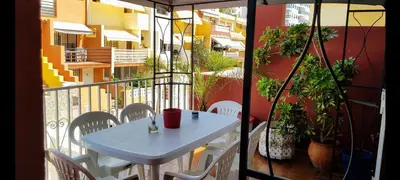 a white table and chairs on a balcony at Adosado playa Pobla Farnals in Puebla de Farnals
