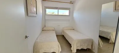 a small room with two beds and a window at Adosado playa Pobla Farnals in Puebla de Farnals
