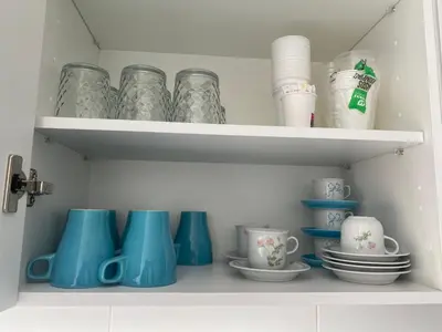 a shelf filled with blue and white cups and plates at Adosado en Playa Casablanca in Almenara
