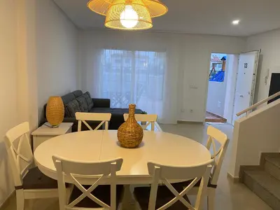a living room with a table with vases on it at Adosado en Playa Casablanca in Almenara
