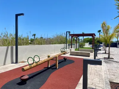 a bench with olympic rings on it in a park at Adosado en Playa Casablanca in Almenara