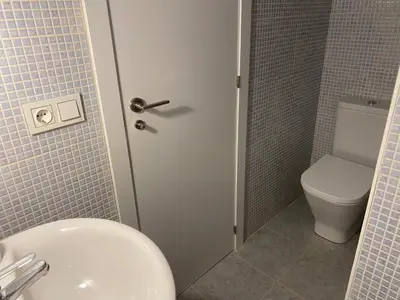 a bathroom with a toilet and a sink at Adosado en Playa Casablanca in Almenara