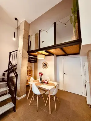 a kitchen and dining room with a table and chairs at Loft Camp del Turia A5 - Housevanlive in Valencia