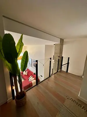 a living room with a red couch in front of a mirror at Loft Camp del Turia A5 - Housevanlive in Valencia