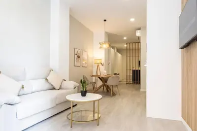 a living room with a white couch and a table at Favara Suites A by Concept Flats in Valencia