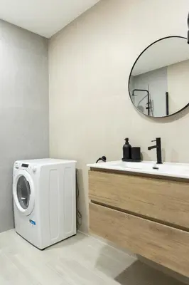 a bathroom with a washing machine next to a sink at Favara Suites A by Concept Flats in Valencia