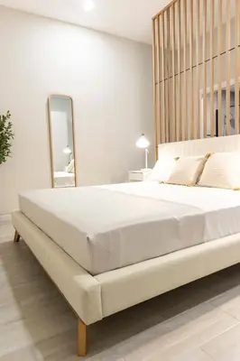a bedroom with a large white bed with a mirror at Favara Suites A by Concept Flats in Valencia