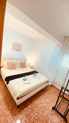 a bedroom with a bed with pink towels on it at Cataleya Apartment in Cullera
