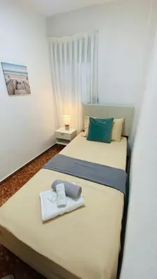 a bedroom with two beds with towels on them at Cataleya Apartment in Cullera