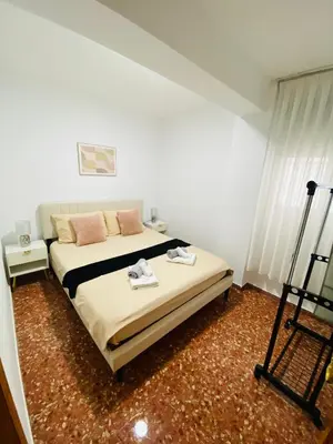 a bedroom with a bed with two towels on it at Cataleya Apartment in Cullera
