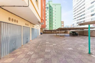 an empty parking lot in a city with tall buildings at Villamar ,ACC, playa wifi y garaje in Cullera