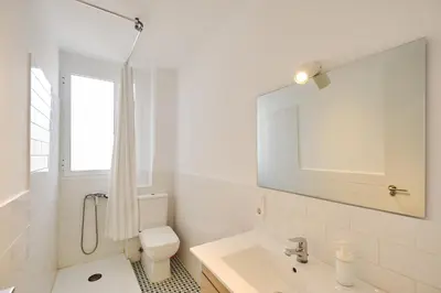 a white bathroom with a toilet and a sink at PATRAIX FLAT in Valencia