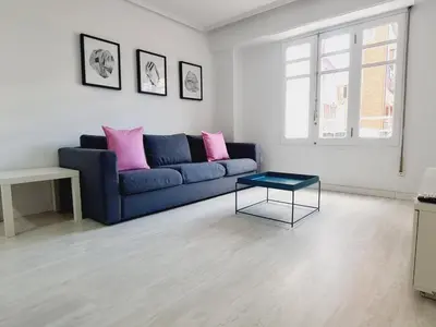 a living room with a blue couch and a table at PATRAIX FLAT in Valencia