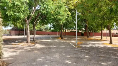 an empty parking lot with trees and a fence at Amazing suite by the fair in Valencia