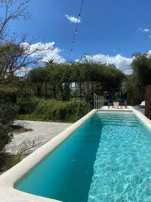 a swimming pool with blue water in a yard at Amazing suite by the fair in Valencia