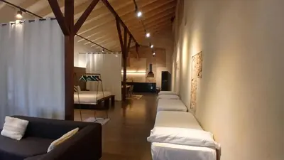 a room with a row of couches and a room with at Amazing suite by the fair in Valencia