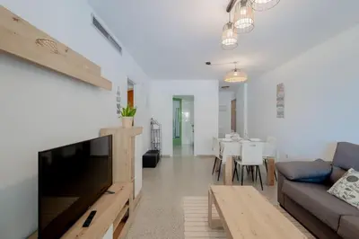 a living room with a couch and a table at Apartamento playa Patacona con parking in Valencia