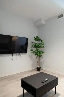 a black coffee table in a living room with a tree at Mediterraneo Stay in Valencia