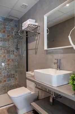 a bathroom with a sink and a toilet and a mirror at Mediterraneo Stay in Valencia