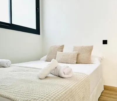 a bedroom with two beds with white towels on them at Valencia Veneta Calda in Valencia