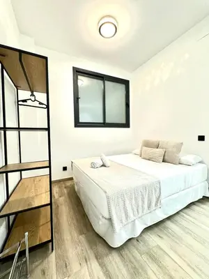 a white bedroom with a bed and a mirror at Valencia Veneta Calda in Valencia