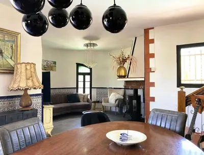 a living room with a table and black balloons hanging from the ceiling at Villa Torre, Valencia Spanje in Macastre