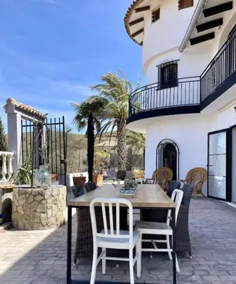 a wooden table and chairs on a patio at Villa Torre, Valencia Spanje in Macastre