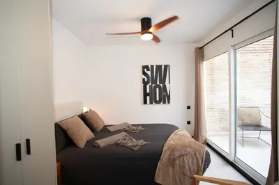 a bedroom with a bed and a ceiling fan at Lovely Exclusivity in Valencia Center in Valencia