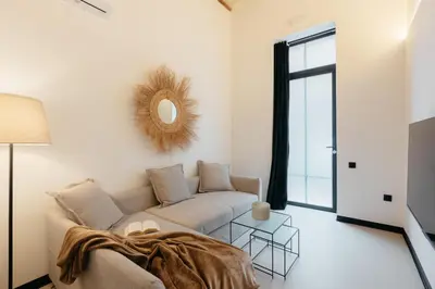 a living room with a couch and a mirror at Lovely Exclusivity in Valencia Center in Valencia