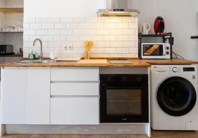 a kitchen with a sink and a dishwasher at Loft Industrial Doble Altura in Valencia