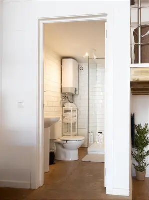 a bathroom with a toilet and a sink at Loft Industrial Doble Altura in Valencia