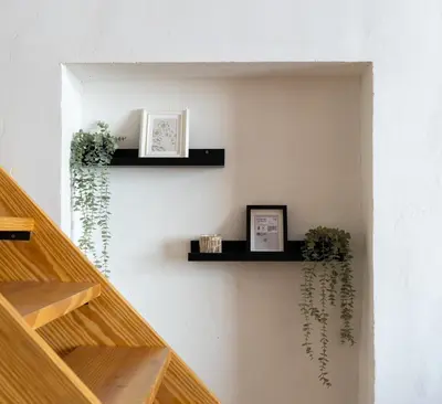 a stairway with two shelves and plants on a wall at Loft Industrial Doble Altura in Valencia