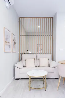 a living room with a white couch and a table at Favara Suites B by Concept Flats in Valencia