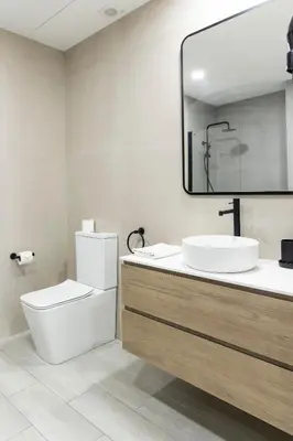 a bathroom with a sink and a toilet and a mirror at Favara Suites B by Concept Flats in Valencia