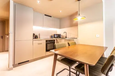 a kitchen and dining room with a wooden table and chairs at Apartamentos 87 Llaves in Valencia