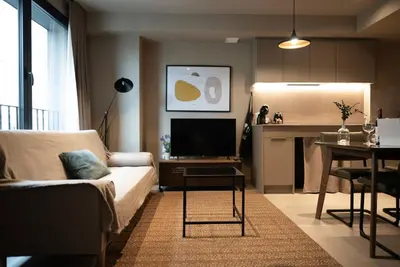 a living room with a couch and a tv at Apartamentos 87 Llaves in Valencia