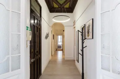 a hallway with white walls and black doors at at Maestro Gozalbo, Ruzafa in Valencia