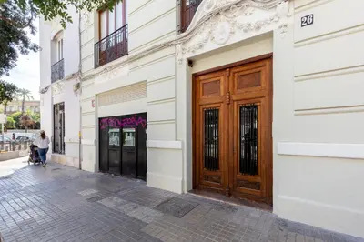 a woman walking down a street in front of a building at at Maestro Gozalbo, Ruzafa in Valencia