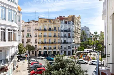 a city street with cars parked in front of buildings at at Maestro Gozalbo, Ruzafa in Valencia
