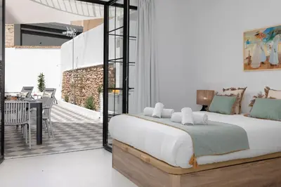 a bedroom with a large bed and a patio at My Loft 4 You Patraix Style in Valencia